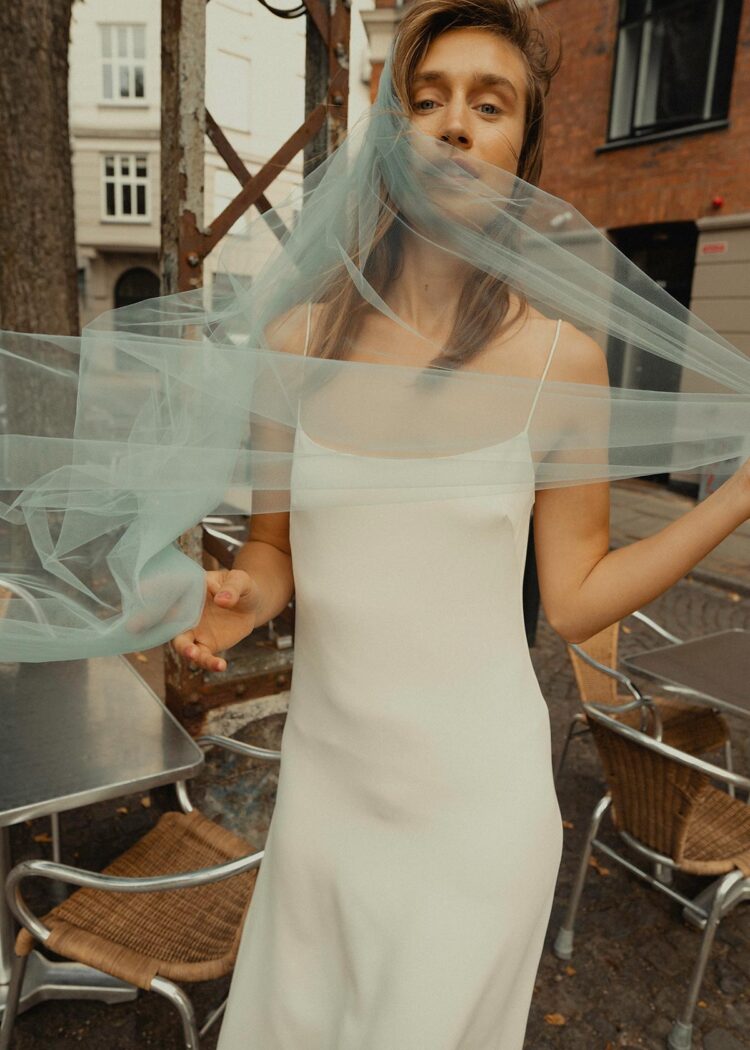 modern bride wrapped in a cloud of an illusion blue wedding veil