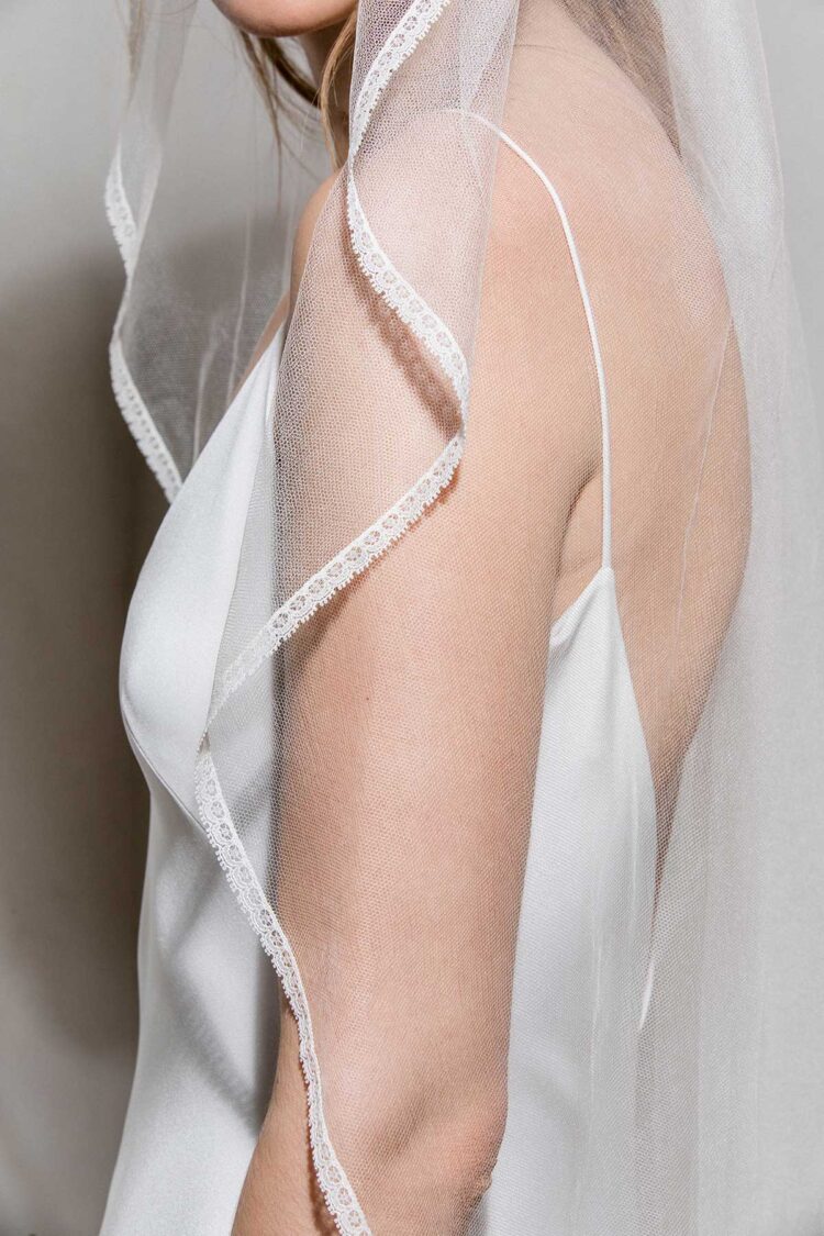 detail of modern bridal veil with delicate thin lace trim