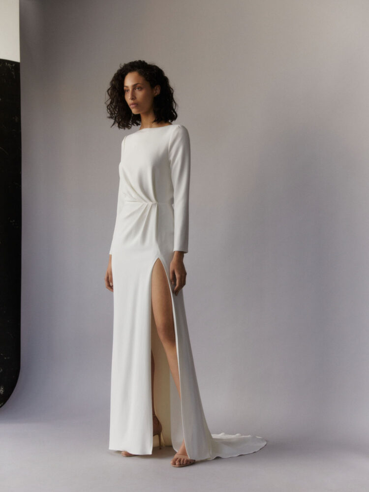 ivory draped gown with slit and long sleeves in heavy crepe